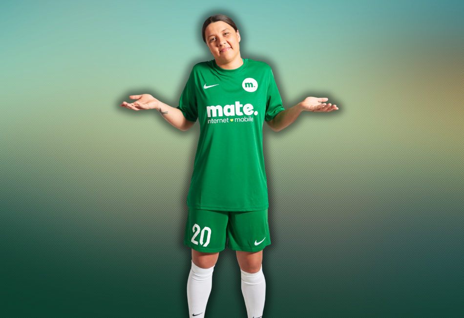 Sam Kerr shrugging her shoulders with her hands out wearing a green soccer kit